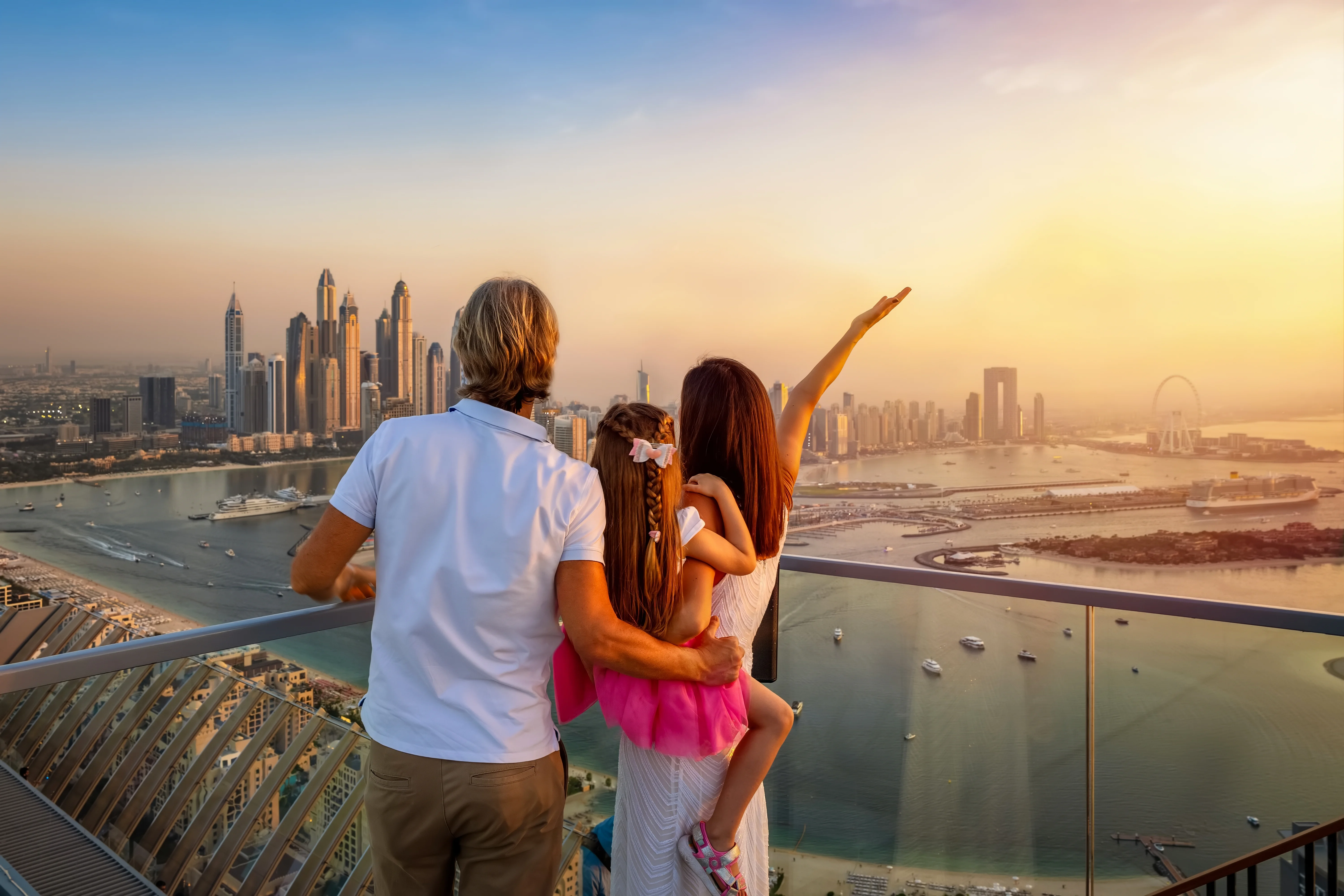 Family enjoying the Dubai skyline view from a balcony, representing the JVC lifestyle